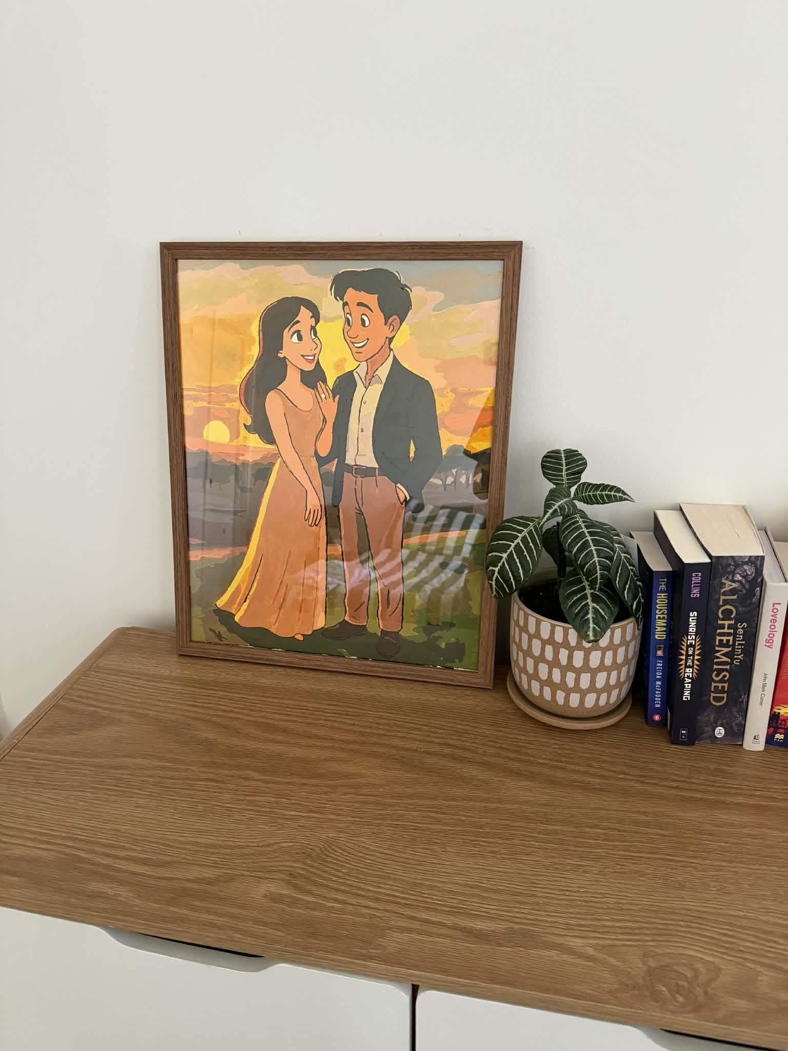 Framed custom engagement portrait painting in sunset tones