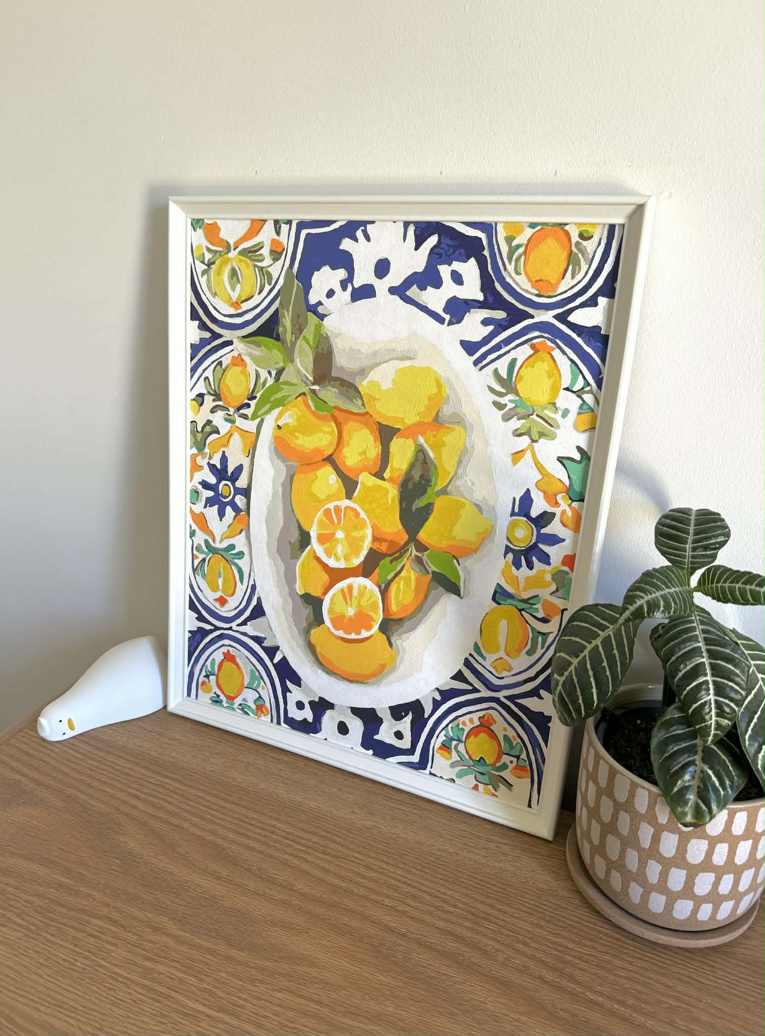 Framed painting of lemons on Mediterranean tiles